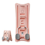 Foldable pink Mini Pilates Reformer with gray foot pedals for core and flexibility workouts