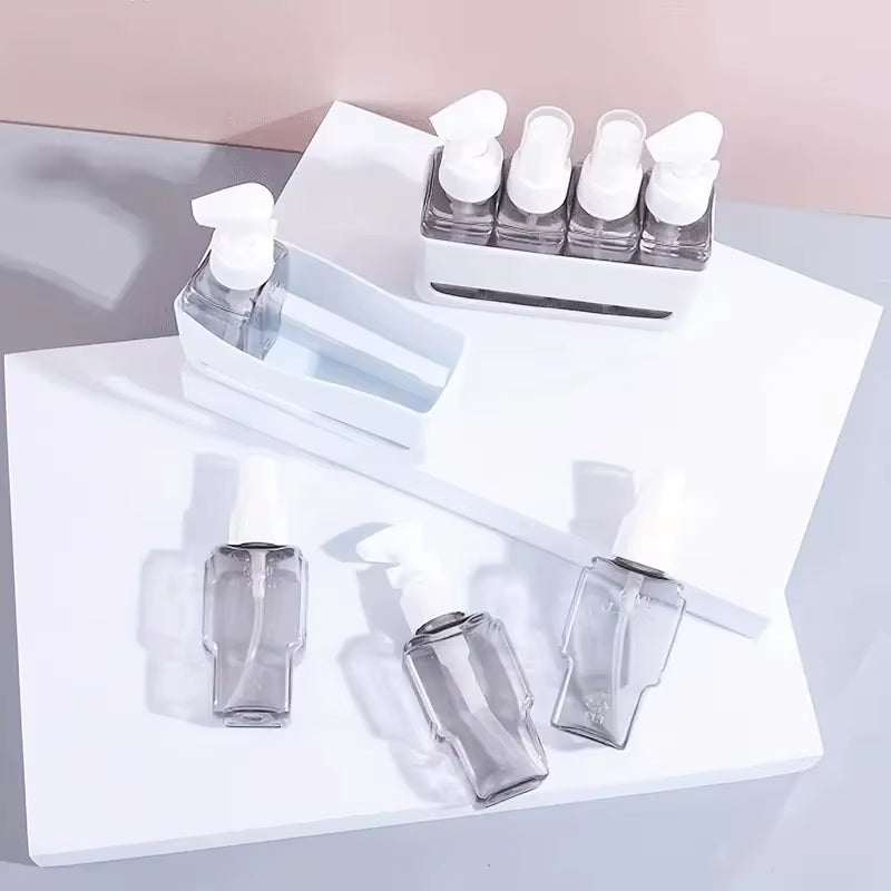 Mini travel toiletry bottle set with refillable clear bottles and white caps for shampoo and lotion